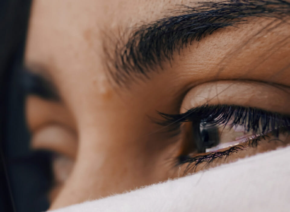 close up woman's eye with tears