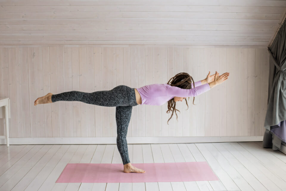 Woman doing yoga to help minimise stress