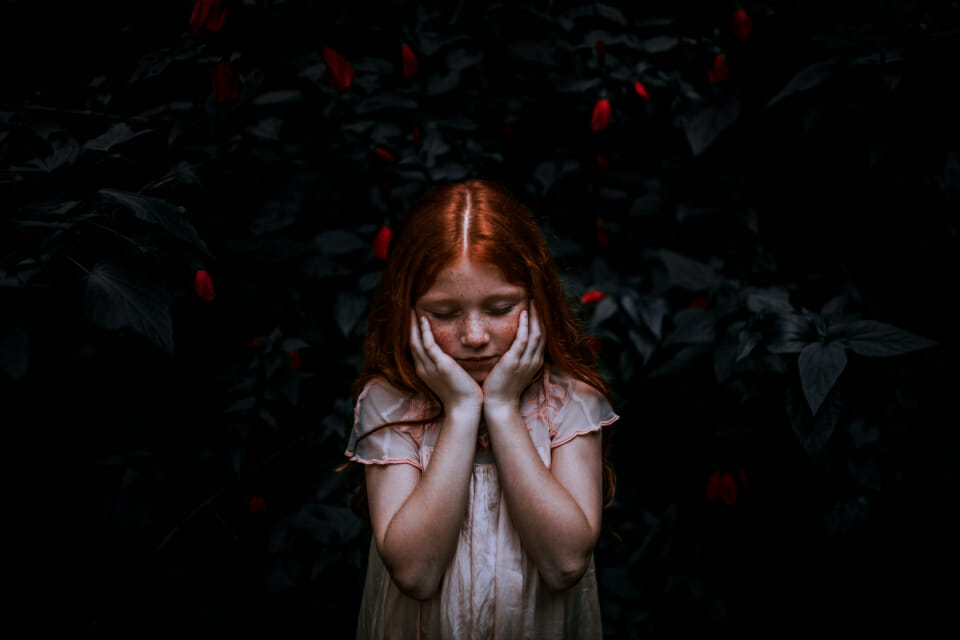 Red haired child thinking with emotion