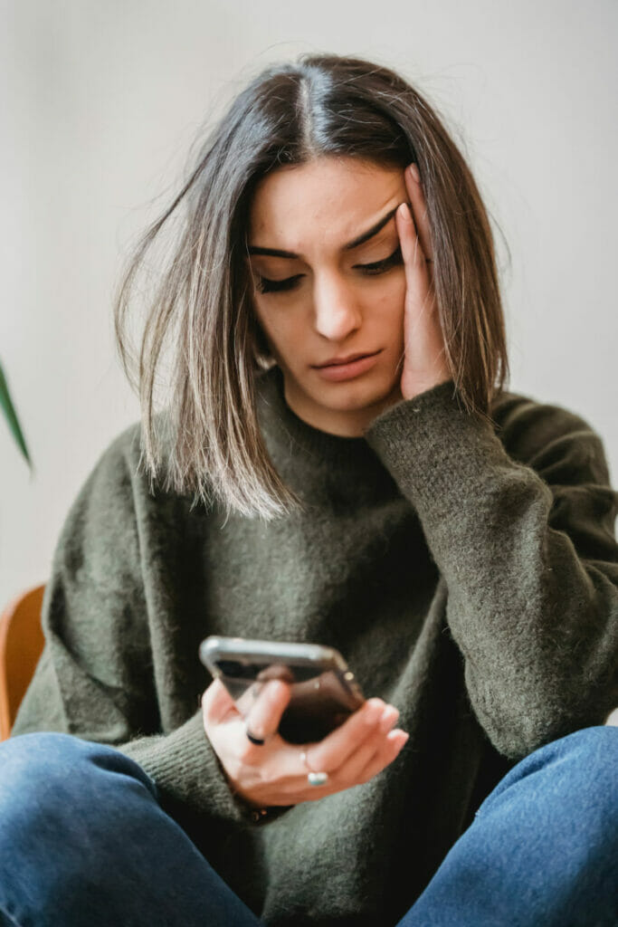 Woman deep in thought on her phone