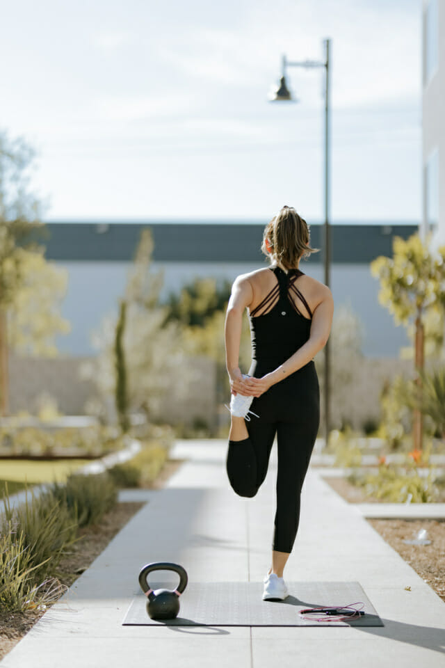 Woman doing exercise with weights and stretches