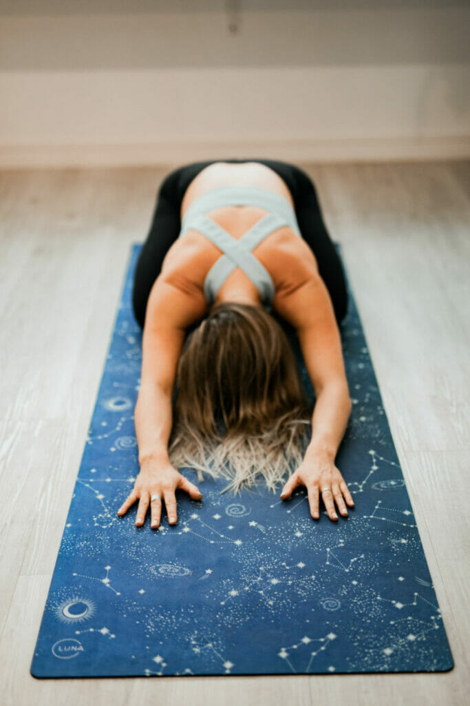 Woman performs yoga poses to help her mental health