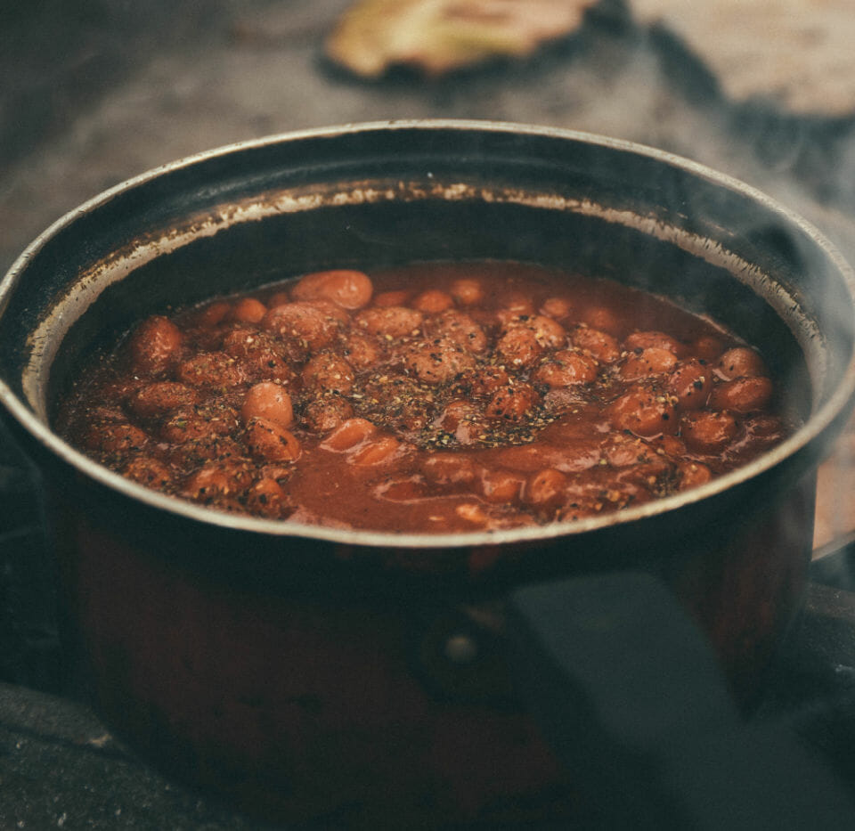 Image of a pot of beans in sauce which aren't on the list of food for period pain