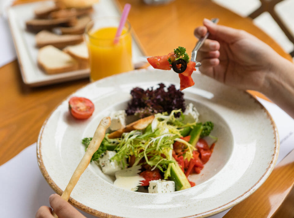 Image of salad with breadsticks and juice 