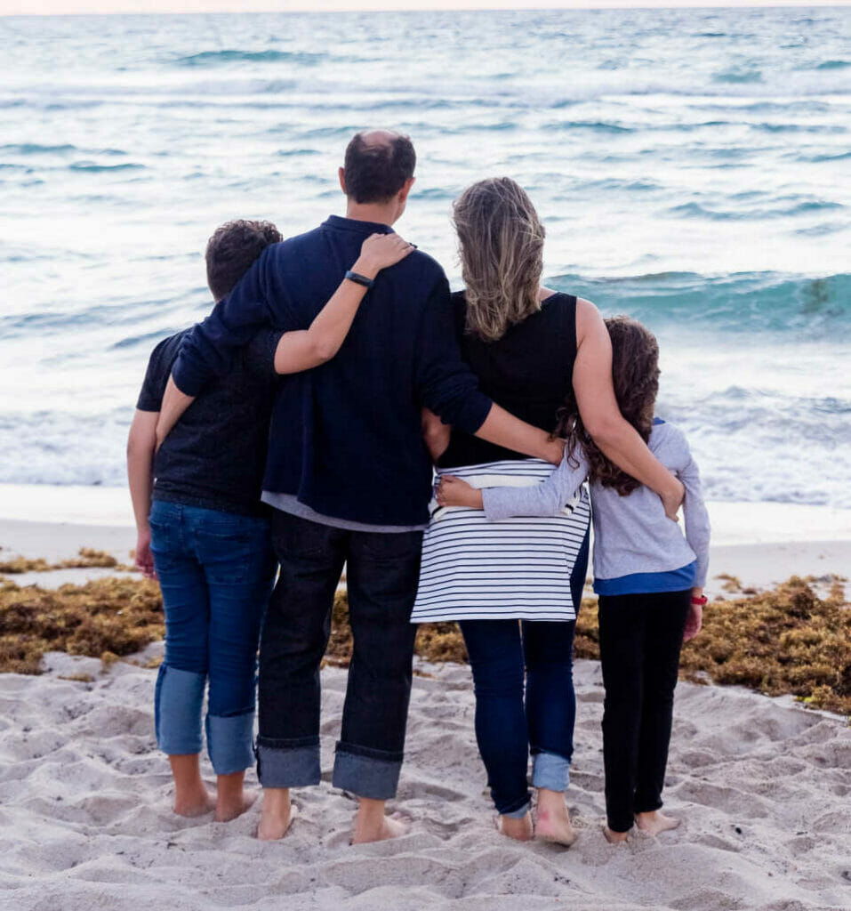 Image of a family on the beach after they've found a way to reconnect as a family