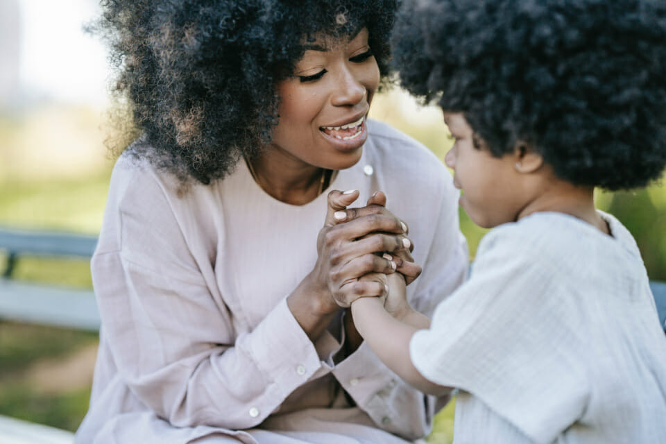 A black mother clutches her sons hand in show of love and solidarity after they expressed some childhood ADHD symptoms