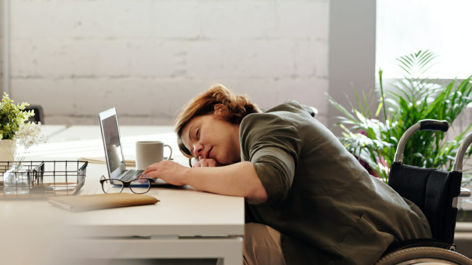 A woman sleeping at her desk - get you sleeping again